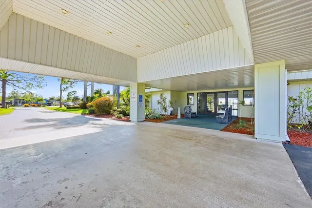 a view of house with swimming pool and outdoor seating