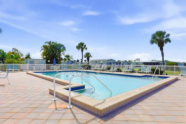 a aerial view of a house with swimming pool and ocean view
