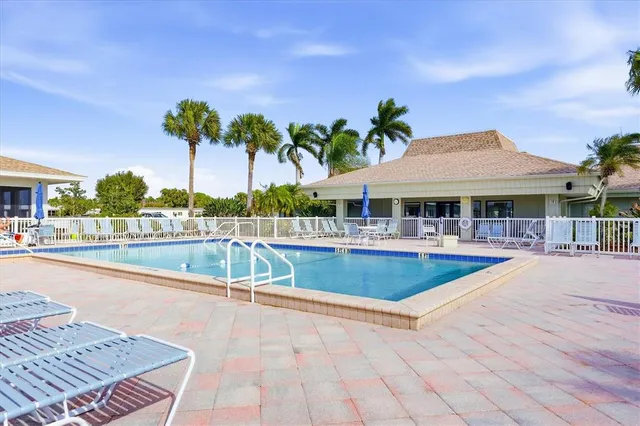 an aerial view of a city with lots of residential buildings and ocean view in back