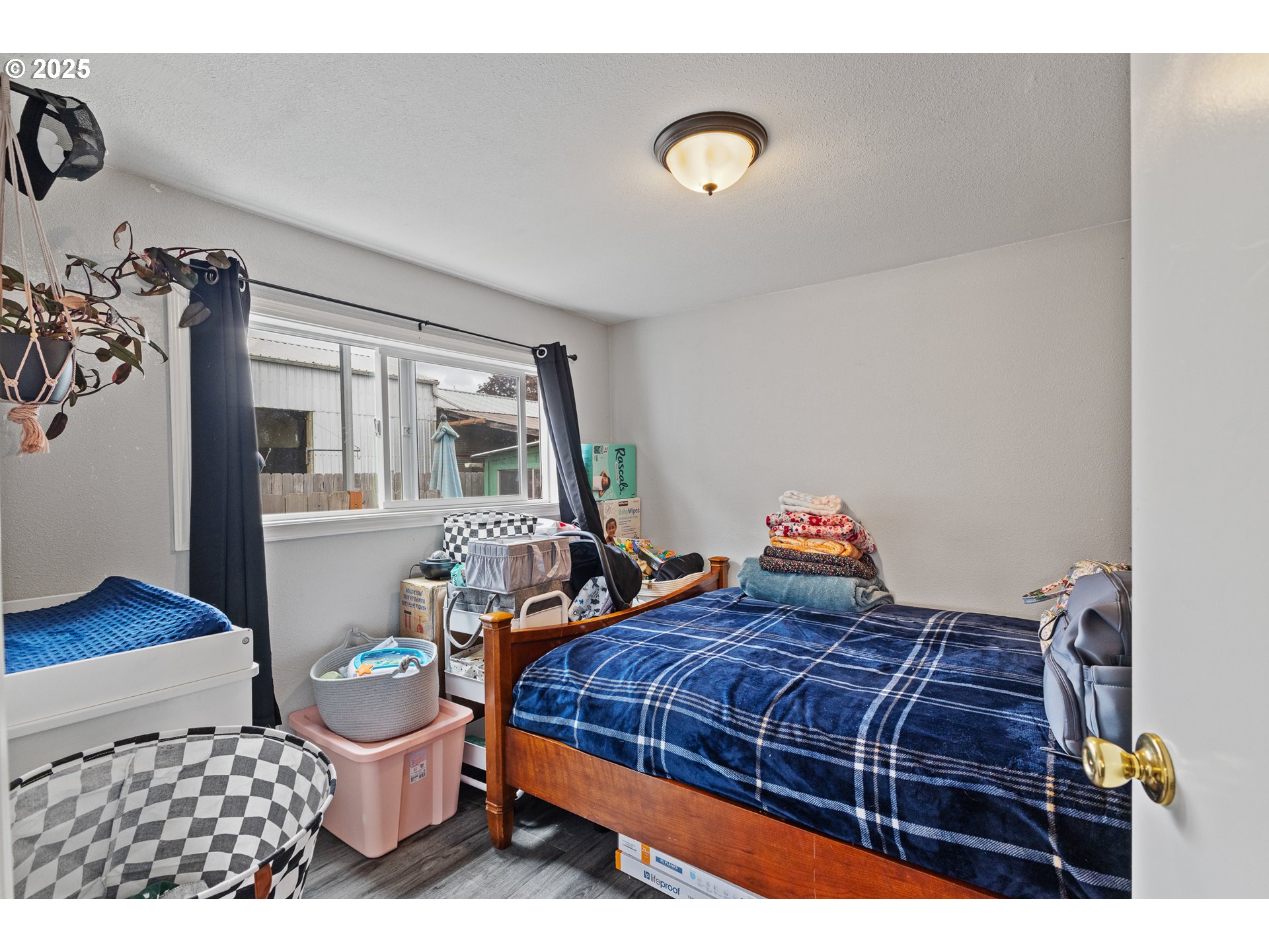 1434 Maryland Avenue Myrtle Point, OR 97458 - Photo 17 of 24 a bedroom with a bed and wooden floor