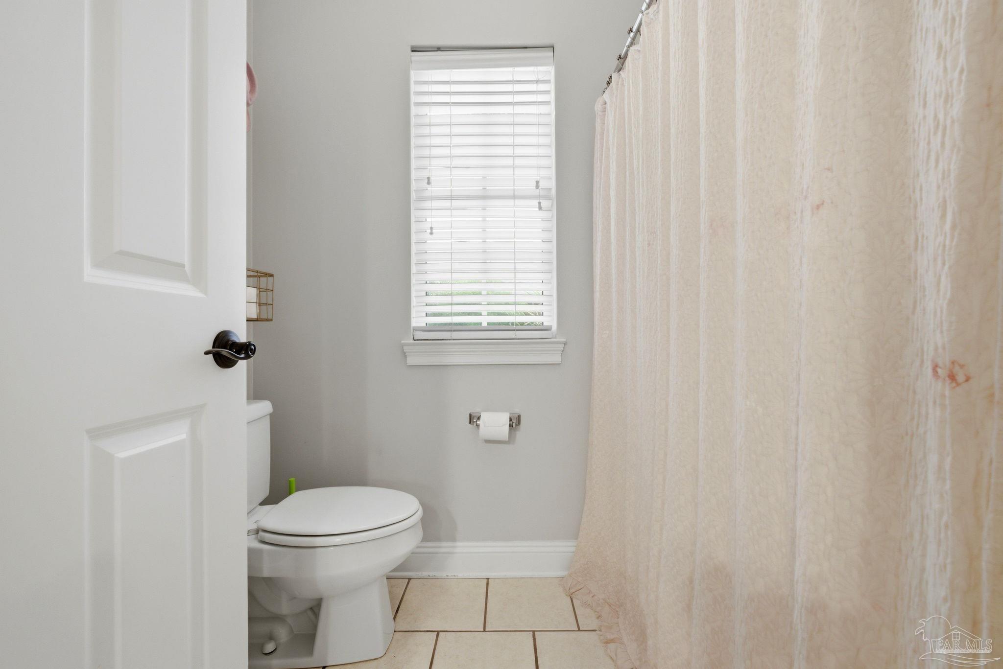 5931 Otter Point Road Pensacola, FL 32504 - Photo 27 of 67 a bathroom with a toilet a sink and a shower