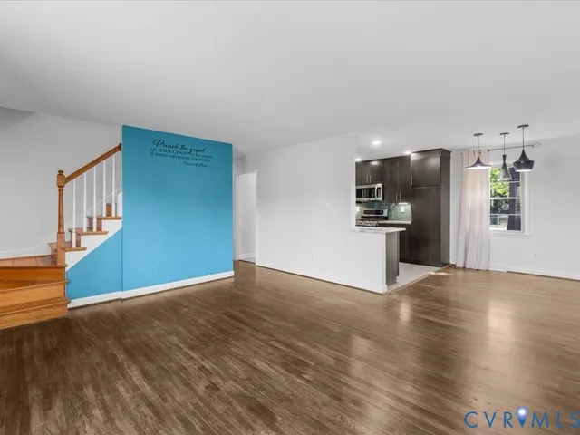 a kitchen with kitchen island a counter top space a sink appliances and cabinets