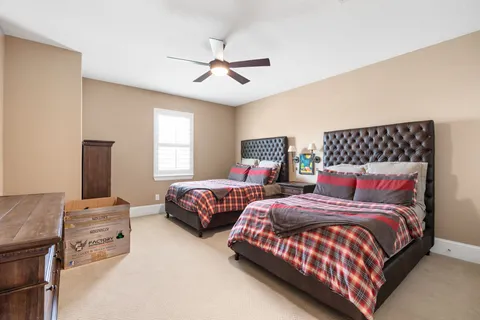 a bedroom with two beds and painting on the wall