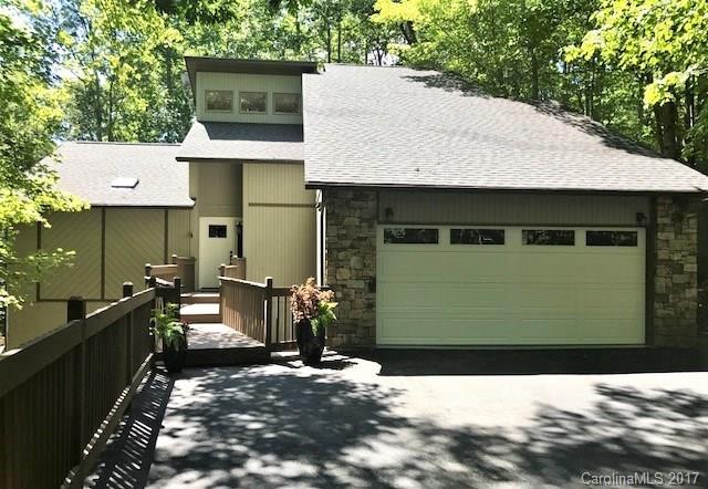 107 Old Distillery Road Hendersonville, NC 28739 - Photo 1 of 24 a view of a house with backyard and sitting area