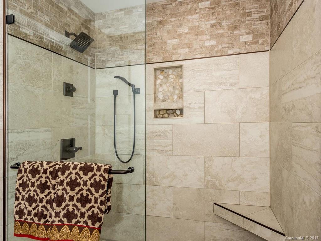 107 Old Distillery Road Hendersonville, NC 28739 - Photo 11 of 24 a bathroom with a glass shower door