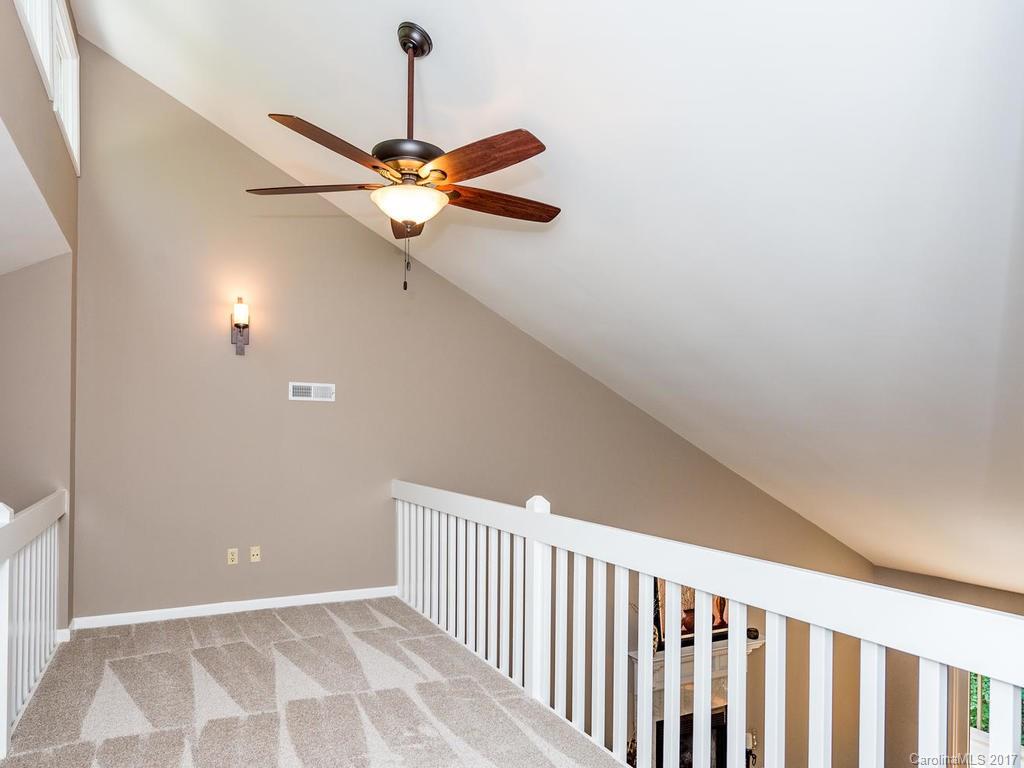 107 Old Distillery Road Hendersonville, NC 28739 - Photo 12 of 24 a view of a hallway with a chandelier