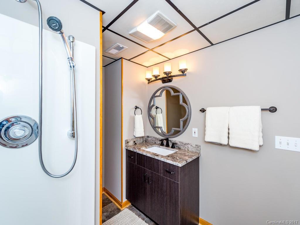 107 Old Distillery Road Hendersonville, NC 28739 - Photo 19 of 24 a bathroom with a sink and a mirror