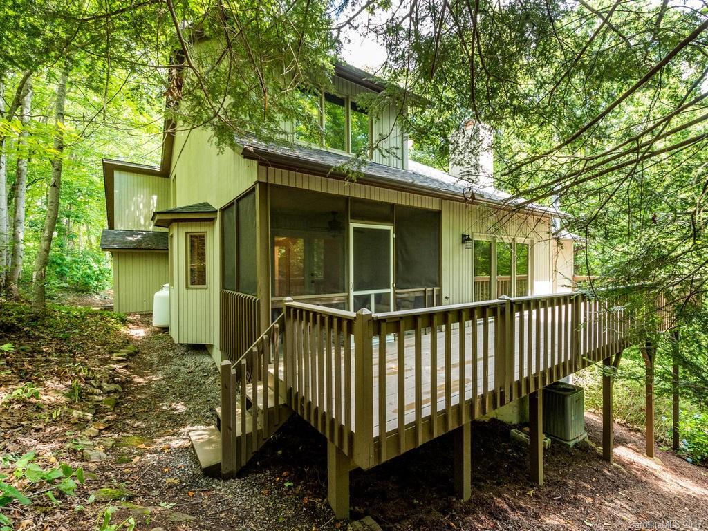 107 Old Distillery Road Hendersonville, NC 28739 - Photo 22 of 24 a view of a chair and table in the backyard