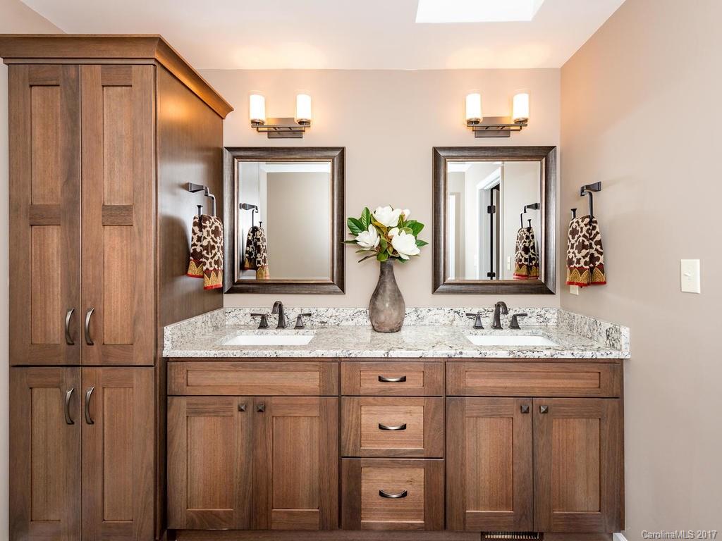 107 Old Distillery Road Hendersonville, NC 28739 - Photo 10 of 24 a bathroom with a double vanity sink and a mirror