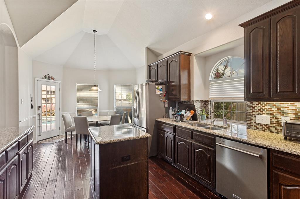 4117 Autumn Path Road Denton, TX 76208 - Photo 5 of 14 Kitchen featuring dark wood cabinetry, granite countertops, and stainless steel appliances