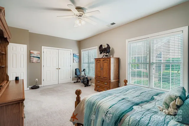 a bedroom with a bed dresser and a window