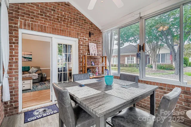 a dining room with furniture and wooden floor