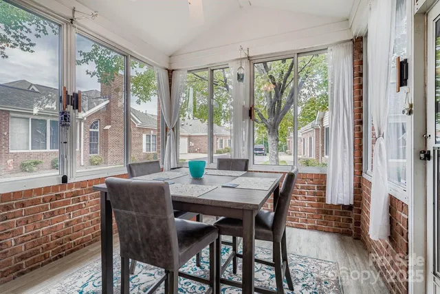 a view of a dining room with furniture large windows and wooden floor