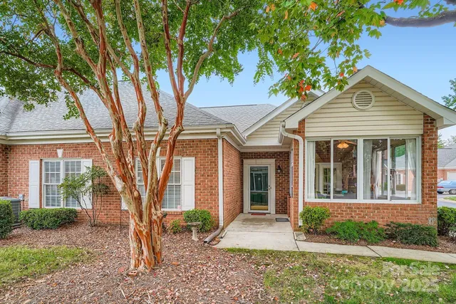 front view of a house with a tree in front