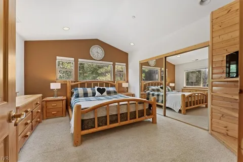 a bedroom with a bed and a flat tv screen