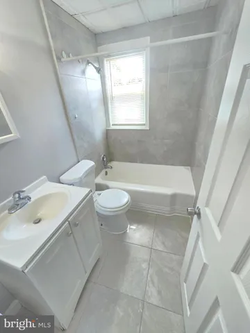 a bathroom with a sink a toilet and bathtub