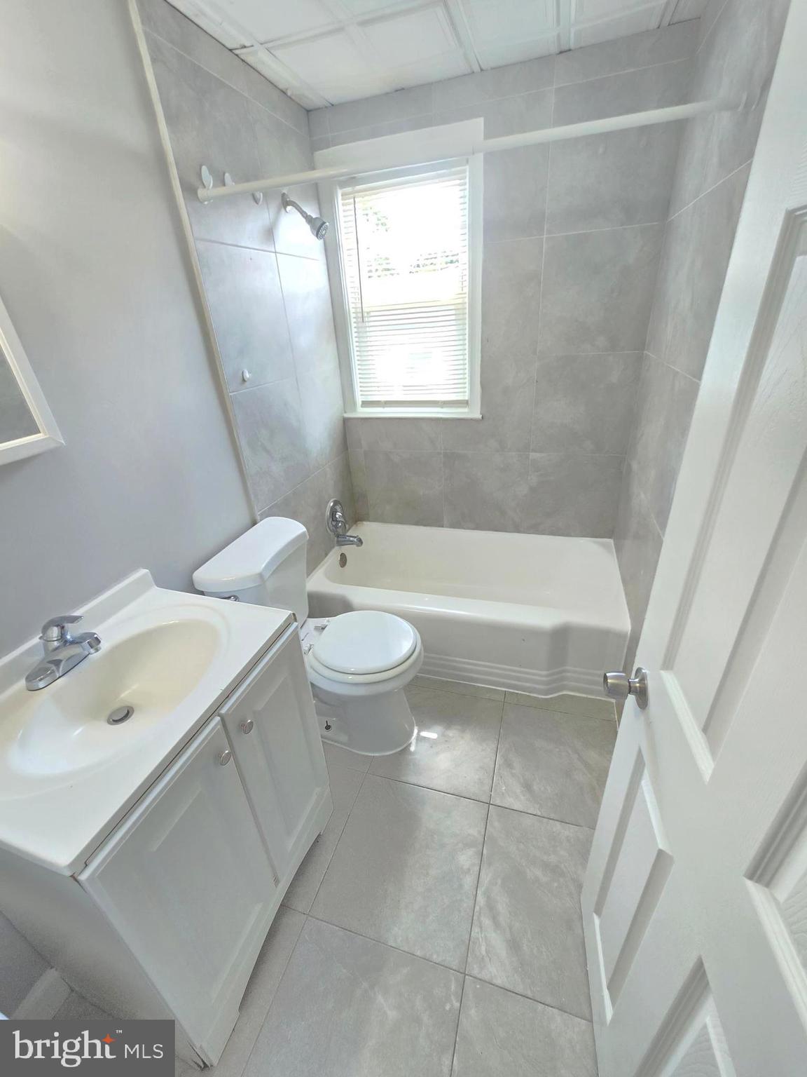 5413 Belle Vista Avenue Baltimore, MD 21206 - Photo 14 of 14 a bathroom with a sink a toilet and bathtub