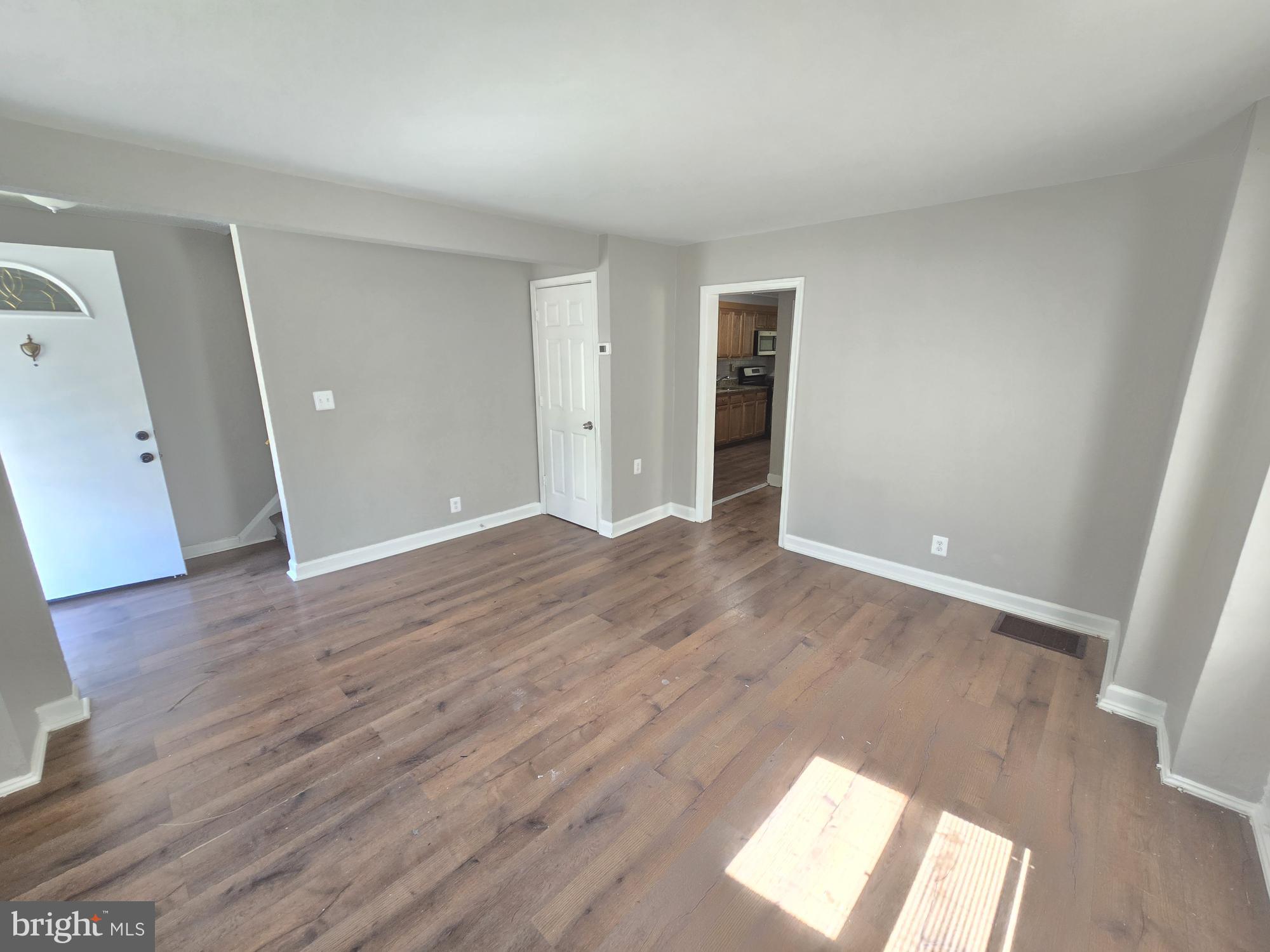 5413 Belle Vista Avenue Baltimore, MD 21206 - Photo 3 of 14 wooden floor in an empty room with a window