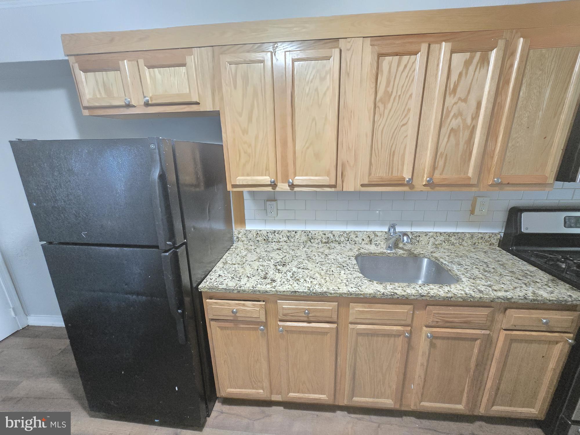 5413 Belle Vista Avenue Baltimore, MD 21206 - Photo 5 of 14 a kitchen with stainless steel appliances granite countertop a refrigerator and a sink