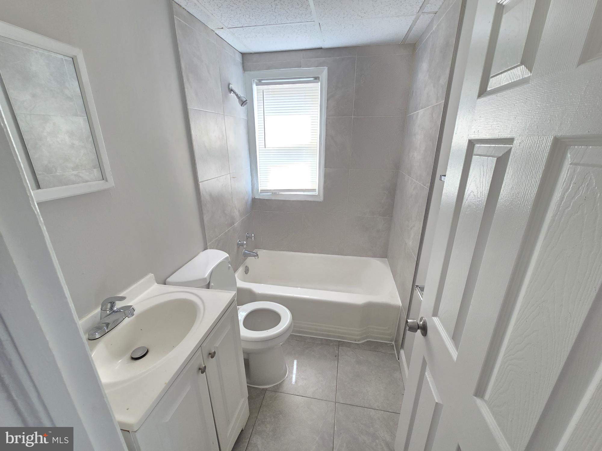 5413 Belle Vista Avenue Baltimore, MD 21206 - Photo 8 of 14 a bathroom with a sink toilet and shower