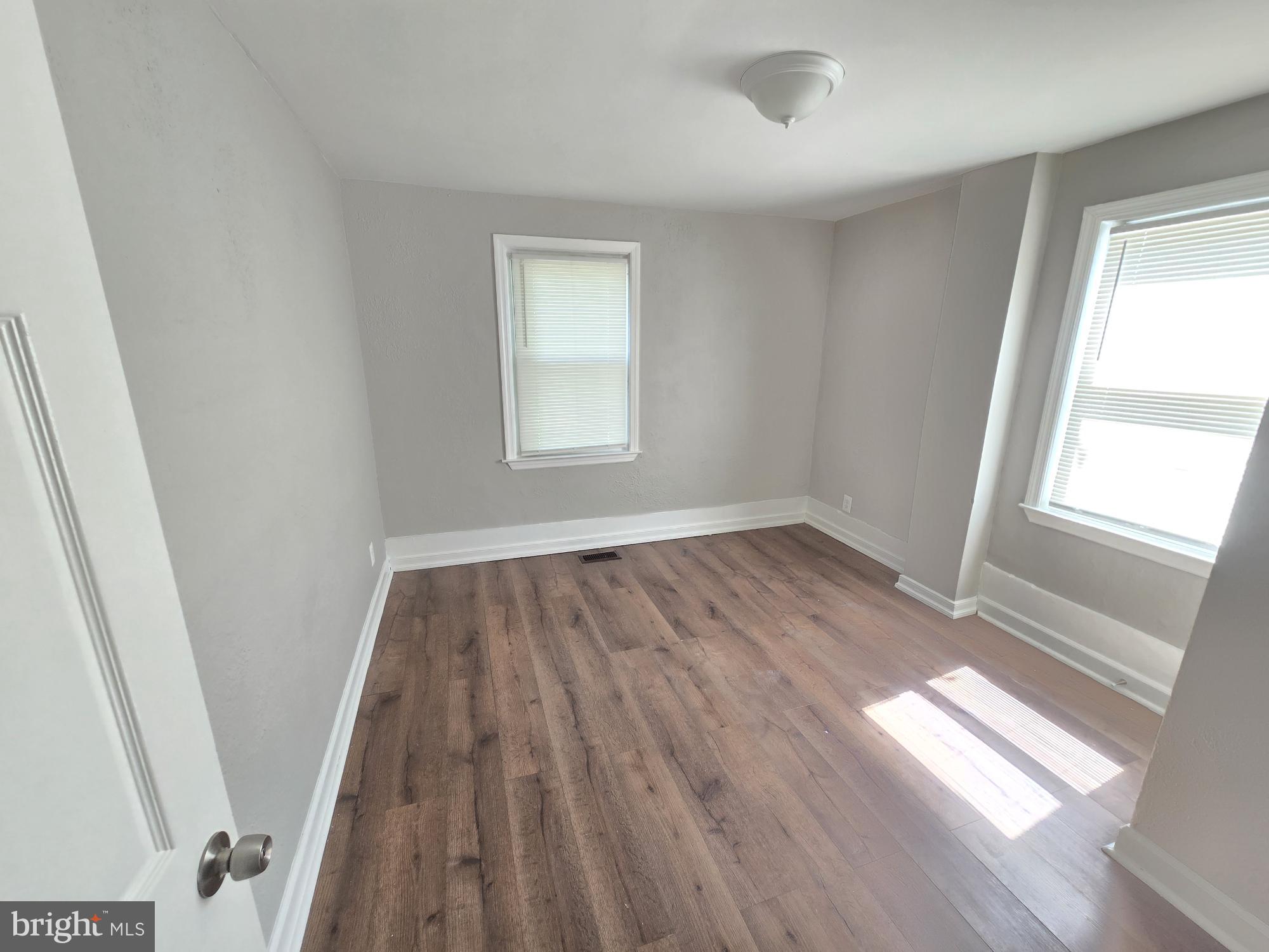 5413 Belle Vista Avenue Baltimore, MD 21206 - Photo 9 of 14 a view of empty room with wooden floor and fan