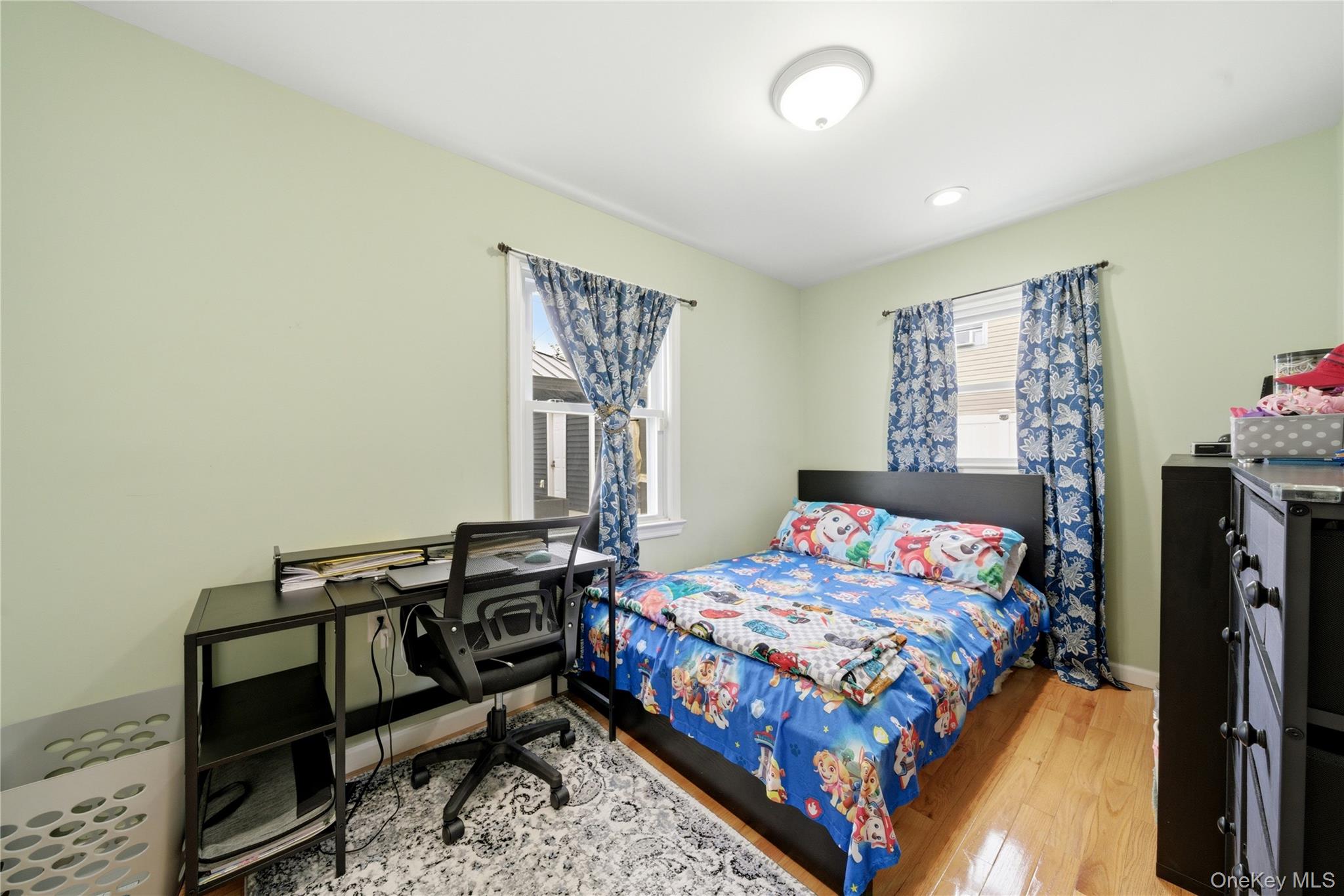 50 Ridge Lane Levittown, NY 11756 - Photo 14 of 27 a bedroom with a bed and a window