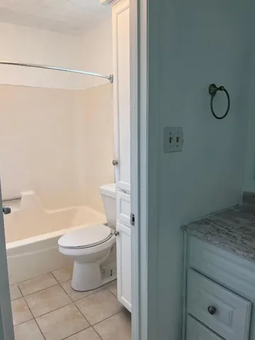 a white toilet sitting next to a bathroom sink