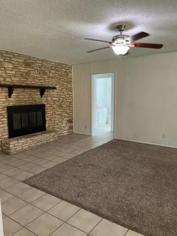 a view of an empty room with a fireplace