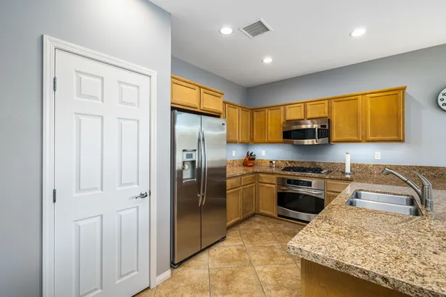 a view of a patio with table and chairs and potted plants