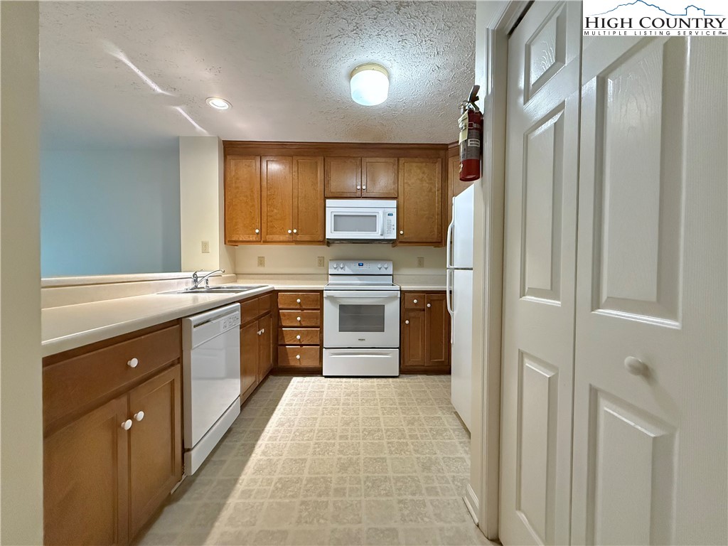 800 Meadowview Drive, Unit 17 Boone, NC 28607 - Photo 13 of 26 a kitchen with stainless steel appliances granite countertop a refrigerator and a sink