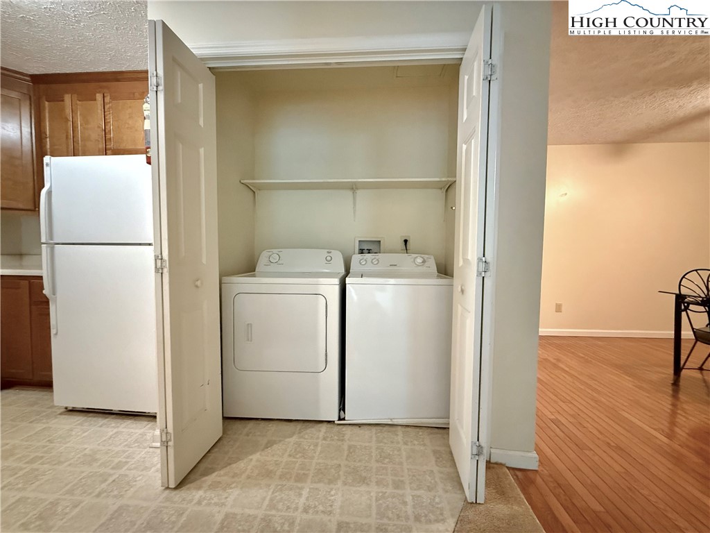 800 Meadowview Drive, Unit 17 Boone, NC 28607 - Photo 14 of 26 a utility room with cabinets washer and dryer