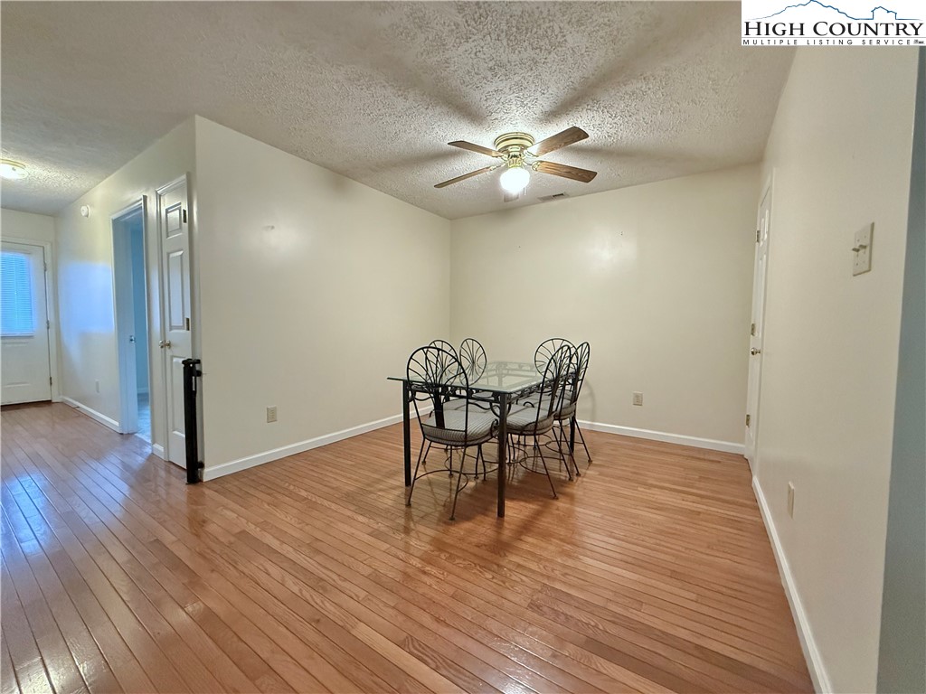 800 Meadowview Drive, Unit 17 Boone, NC 28607 - Photo 16 of 26 a view of a dining room with furniture and wooden floor