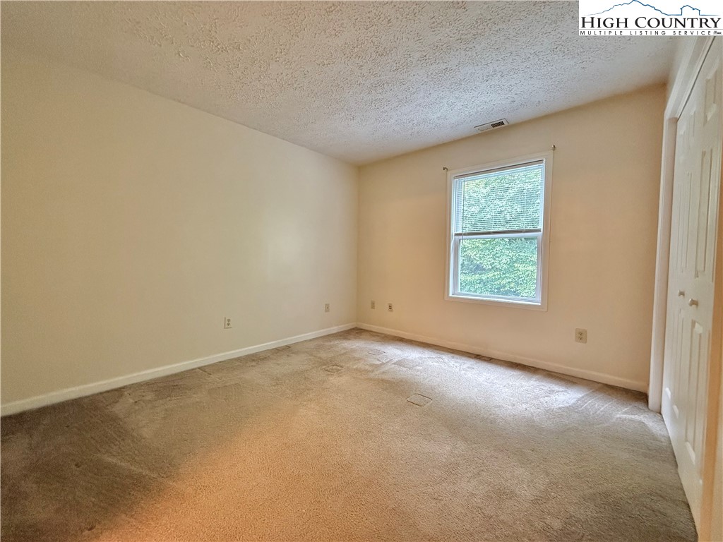 800 Meadowview Drive, Unit 17 Boone, NC 28607 - Photo 18 of 26 an empty room with windows