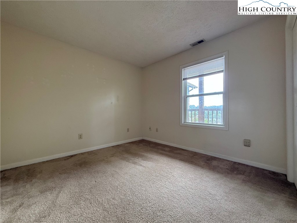 800 Meadowview Drive, Unit 17 Boone, NC 28607 - Photo 21 of 26 an empty room with a window
