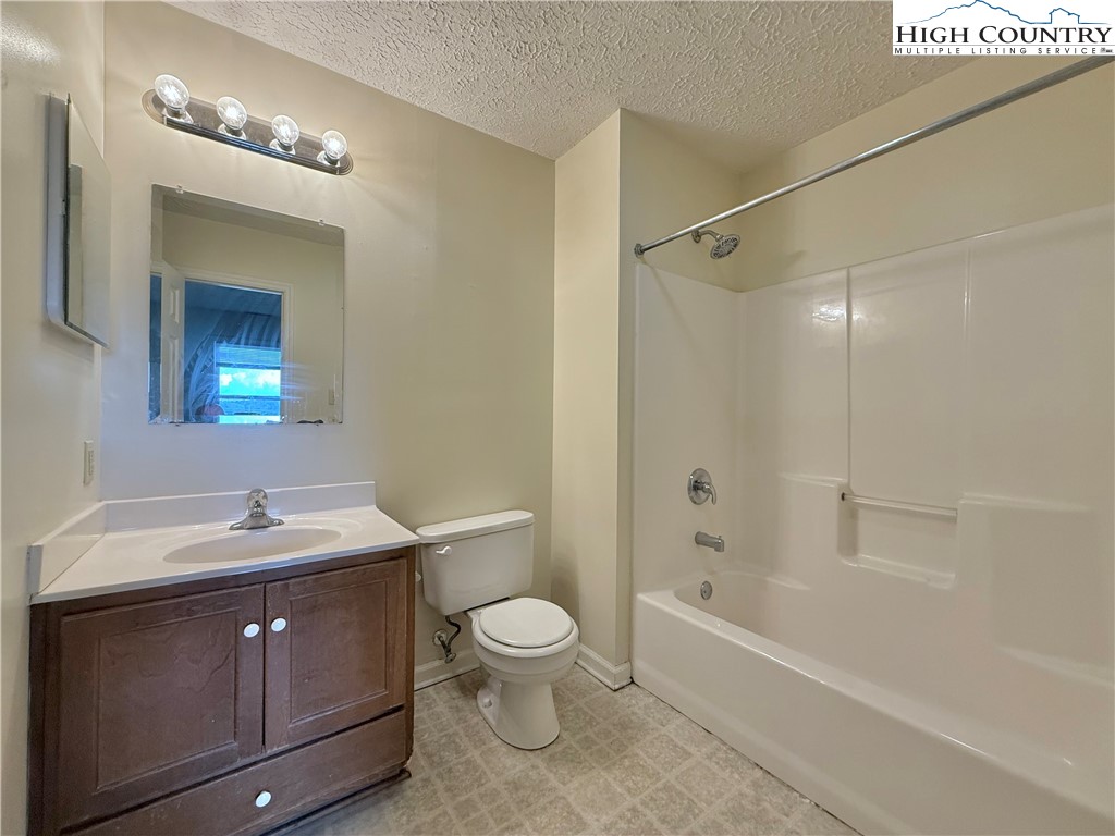 800 Meadowview Drive, Unit 17 Boone, NC 28607 - Photo 22 of 26 a spacious bathroom with a sink a toilet a mirror and shower