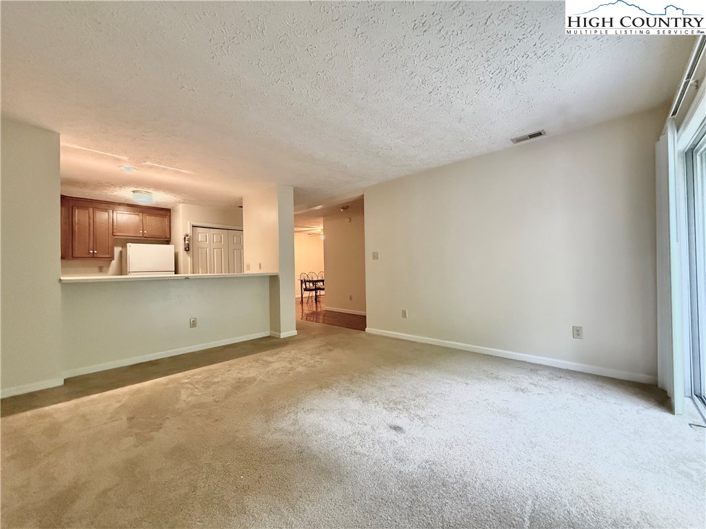 800 Meadowview Drive, Unit 17 Boone, NC 28607 - Photo 7 of 26 an empty room with a cabinet and mirrors