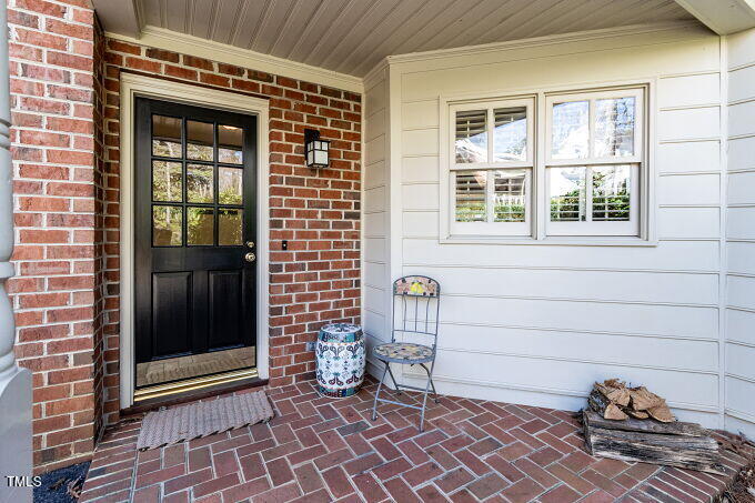 3005 Woodgreen Drive Raleigh, NC 27607 - Photo 5 of 13 a view of a door and chair and table in front of house