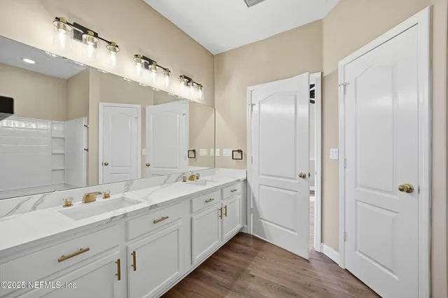 a spacious bathroom with a double vanity sink mirror and double