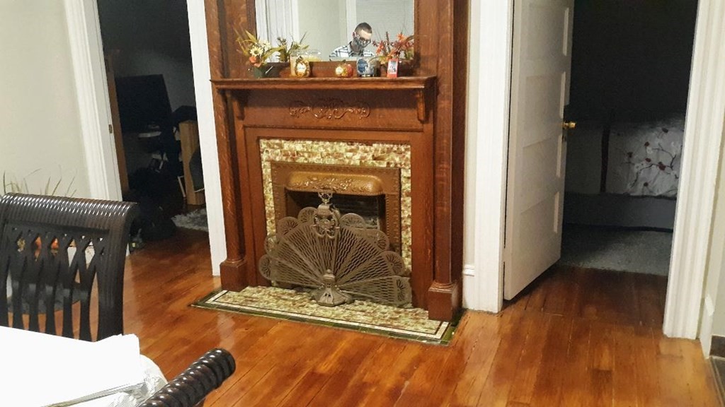 242 Stafford Road Fall River, MA 02721 - Photo 19 of 19 a living room with a fireplace windows and wooden floor