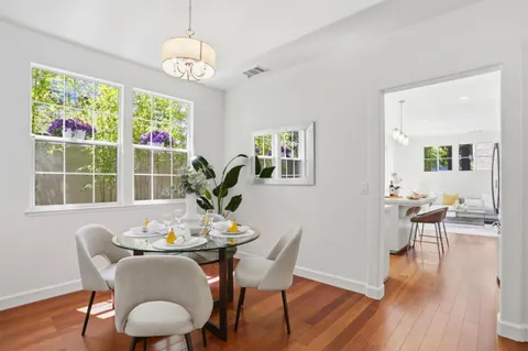 a view of a dining room with furniture window and wooden floor