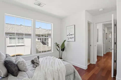 a bedroom with a bed and wooden floor