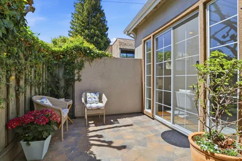 a building view with a seating space and potted plants
