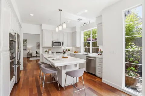 a large kitchen with a table and chairs in it