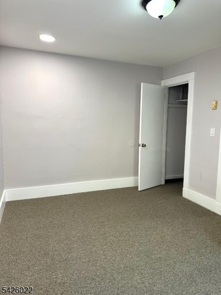 82 Mission Street Montclair, NJ 07042 - Photo 6 of 8 an empty room with a ceiling fan and window