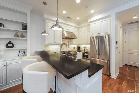 a kitchen with a table chairs sink and cabinets