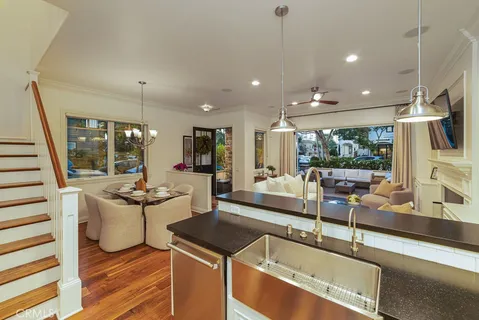 a bedroom with a large bed a flat tv screen and a chandelier