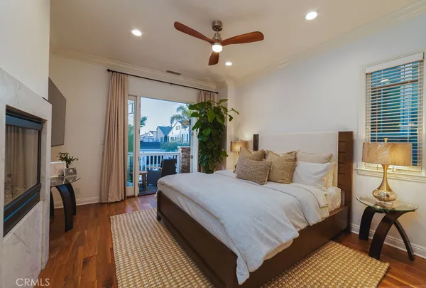 a bedroom with a bed potted plant and a large window
