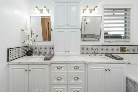 a bathroom with a double vanity sink mirror and double