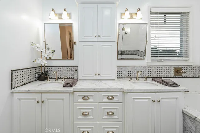 a bathroom with a double vanity sink mirror and double