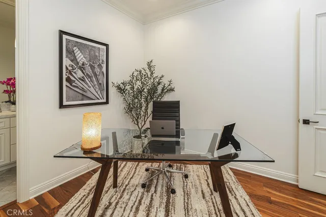 a view of a workspace with furniture and wooden floor